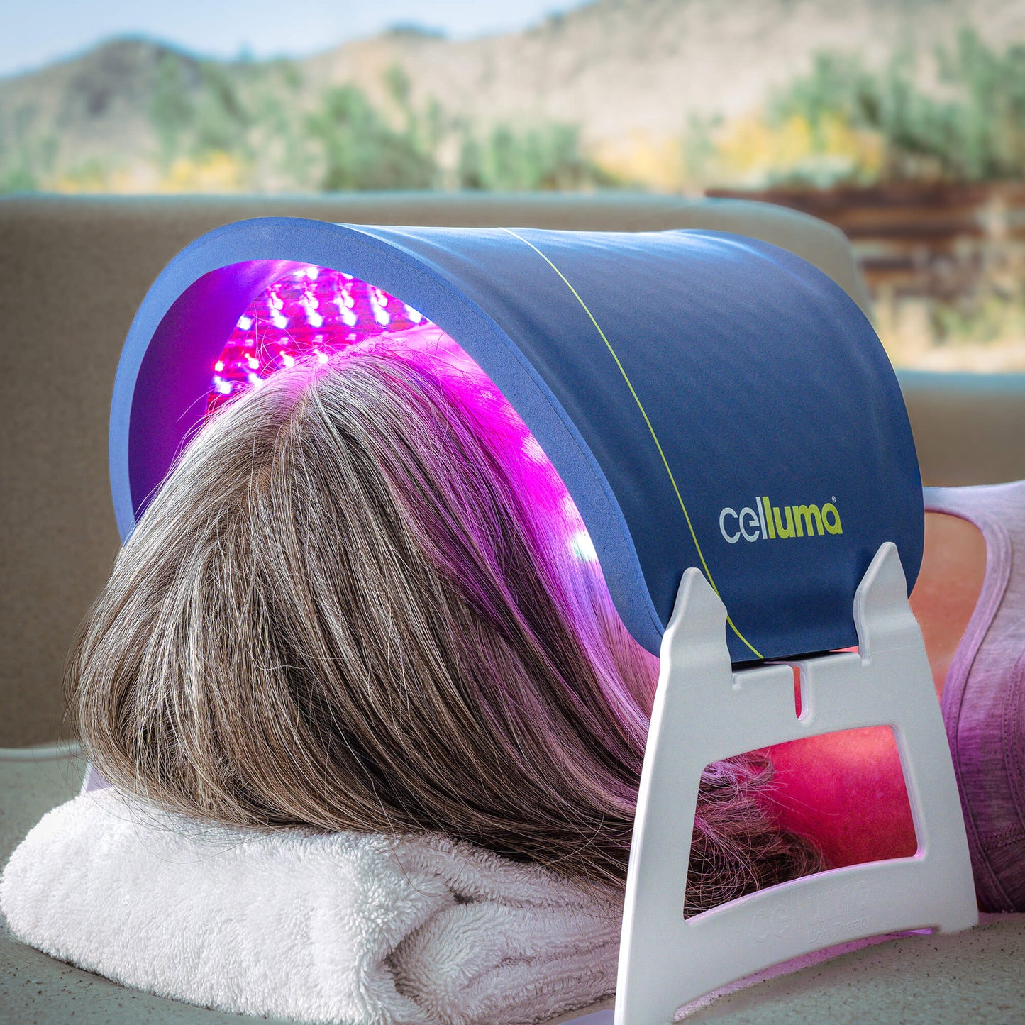 Person receiving LED light therapy treatment with a Celluma Lite Series 2 Therapy Mask Outdoors