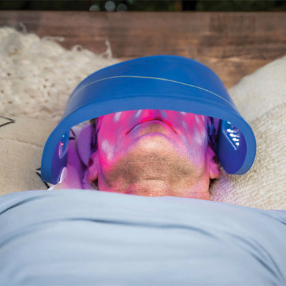 Man lying down receiving red light therapy facial using Celluma Lite Series 2 Face Mask