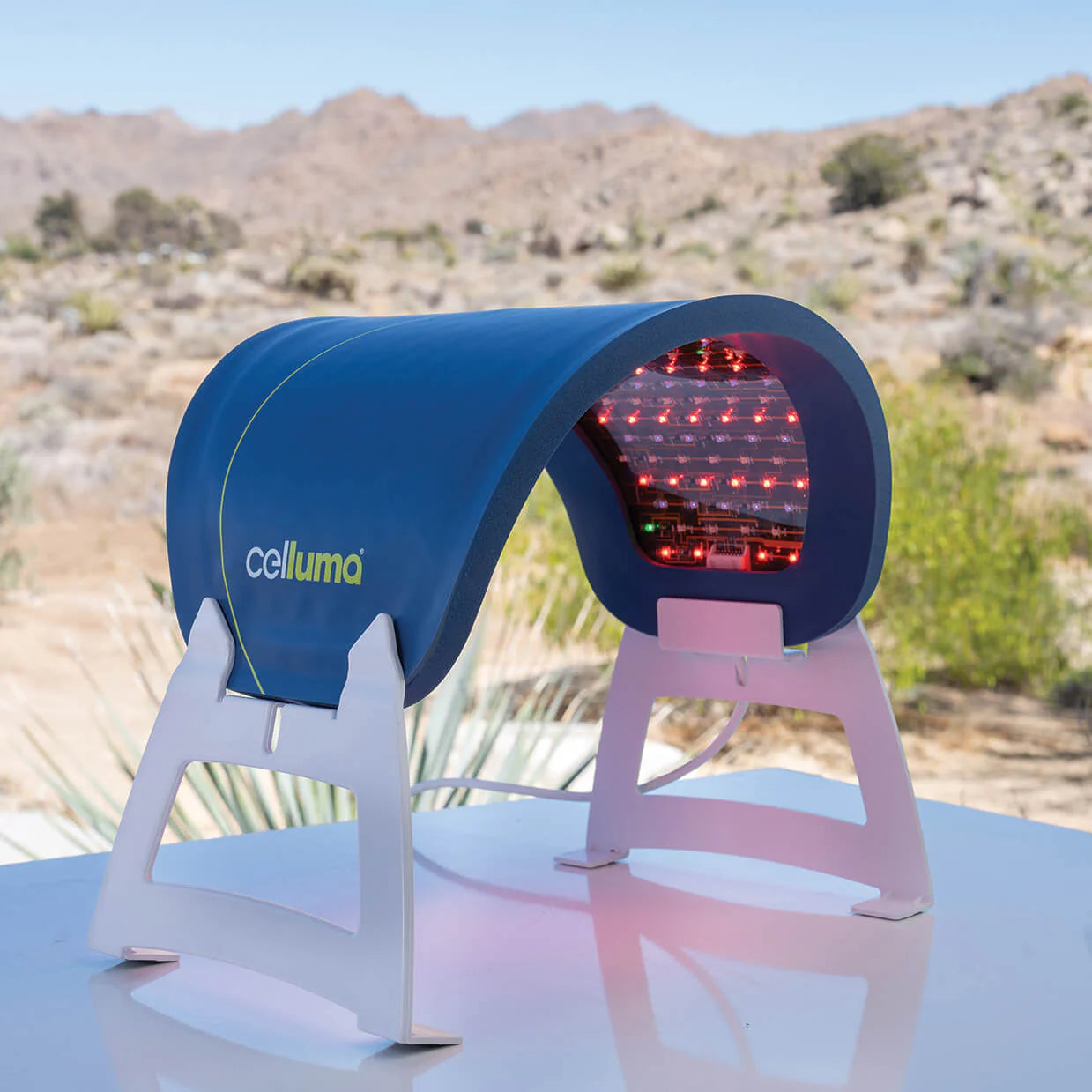 Celluma Lite Series 2 Red Light Therapy Mask on a stand outdoors