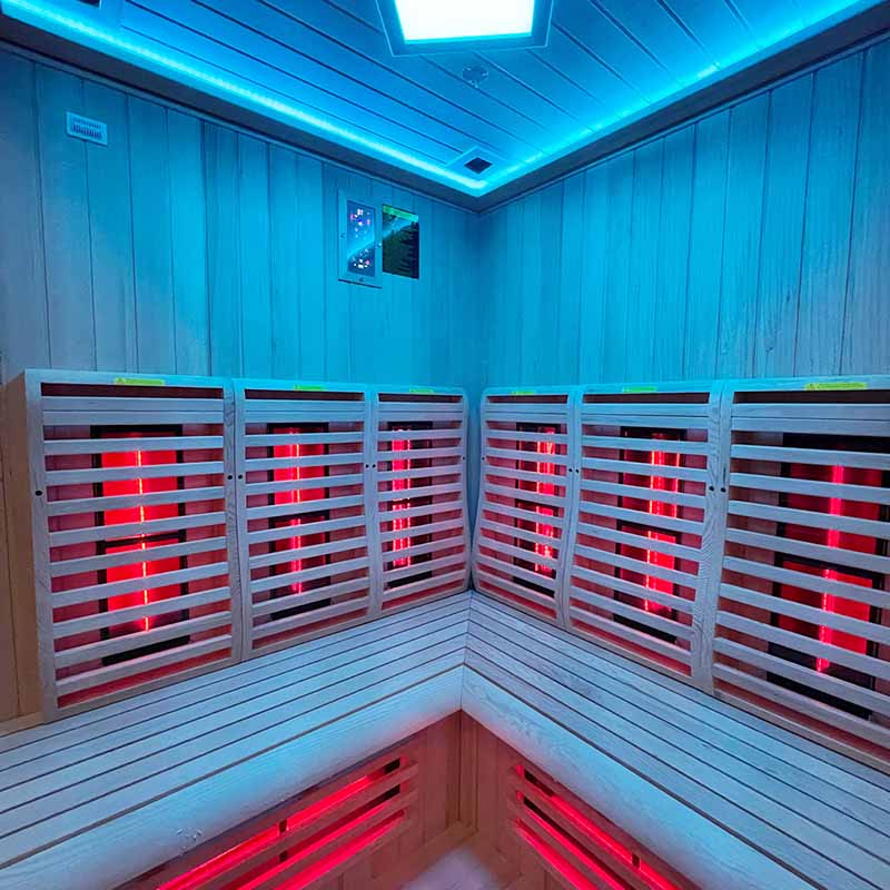 Insignia KY007 corner infrared sauna 1500×1500mm, interior with red heaters and blue chromotherapy LEDs.