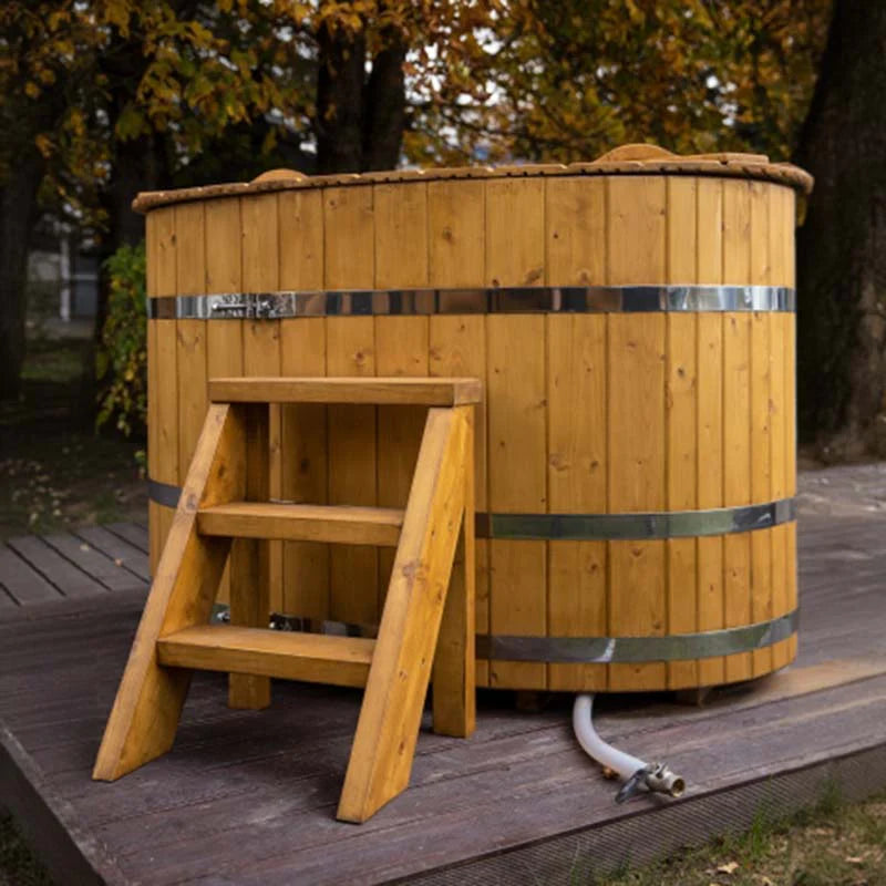 Viking Industrier 2-person oval cold tub, spruce wood with entry steps and visible drain hose.