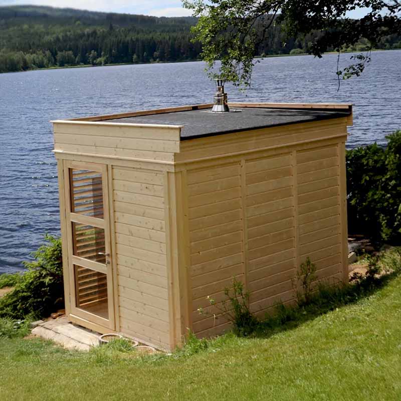 Viking Industrier Sauna Cube 2x3m positioned by a lake in a scenic outdoor setting, perfect for home or garden wellness.